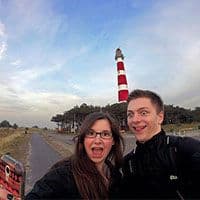 Sonia F. and her boyfriend taking a selfie in front of a lighthouse